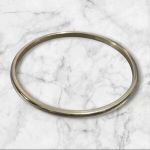 VIntage Monet silver-tone bangle bracelet with a sleek, minimalist design.